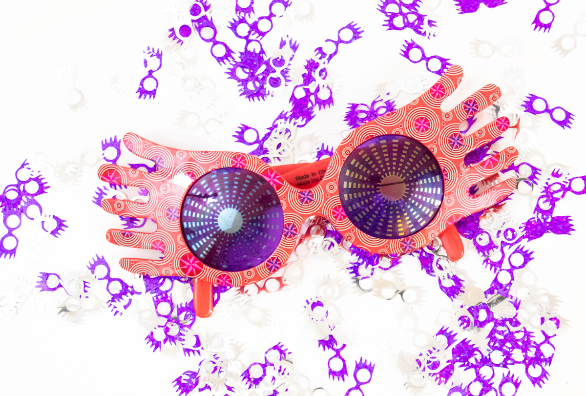 luna love good glasses surrounded by matching confetti Have you ever wondered how to cut Cricut Party Foil? Here are all the answers you need to know. Create this Harry Potter party confetti using Luna Lovegood's Sprectrespecs SVG file and create your own Harry Potter party. #harrypotterparty #lunalovegood #cricutmade #cricutpartyfoil
